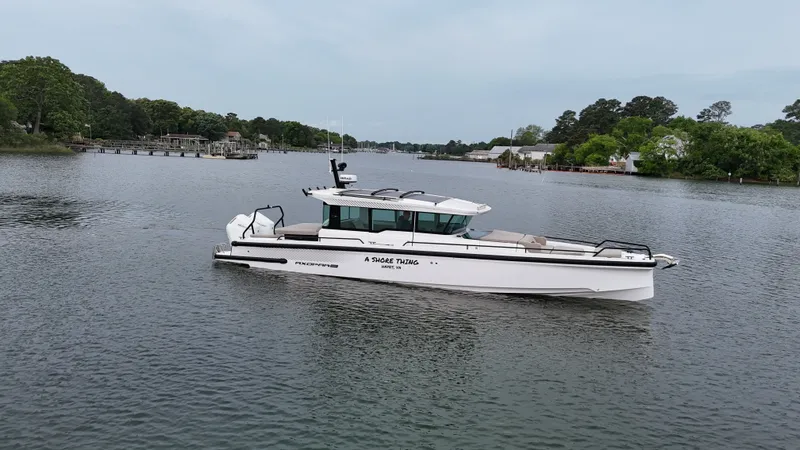 Slide: The Image of Axopar 37 XC Cross Cabin 2025 on a serene river. - 27