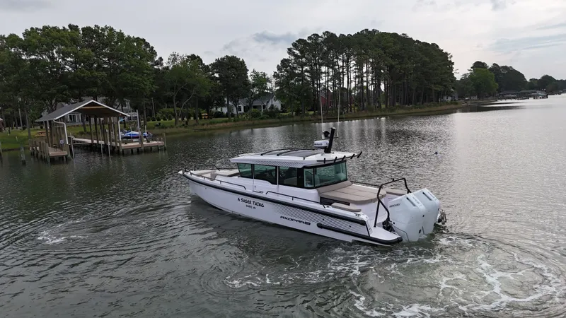 Slide: The Image of Axopar 37 XC Cross Cabin 2025 on a serene lake. - 29