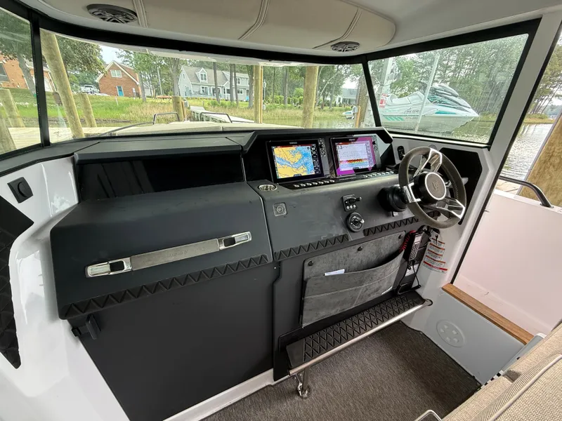 Slide: The Image of Interior of 2025 Axopar 37 XC Cross Cabin with modern helm console. - 3
