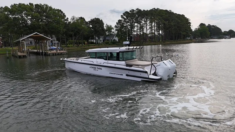 Slide: The Image of 2025 Axopar 37 XC Cross Cabin on calm waters. - 30