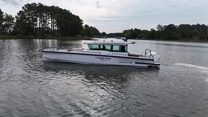 Slide: The Image of 2025 Axopar 37 XC Cross Cabin on calm waters. - 31