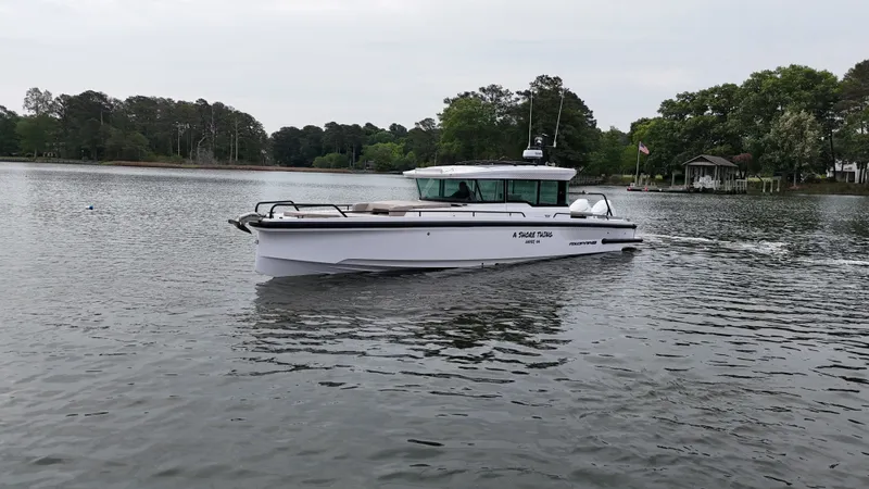 Slide: The Image of Axopar 37 XC Cross Cabin 2025 on a tranquil lake. - 32