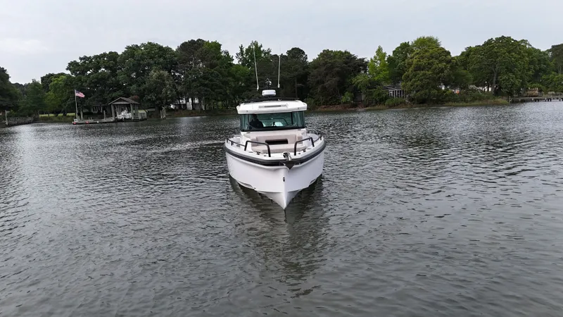 Slide: The Image of Axopar 37 XC Cross Cabin 2025 on a tranquil lake. - 33