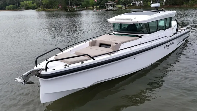 Slide: The Image of 2025 Axopar 37 XC Cross Cabin on calm waters. - 35