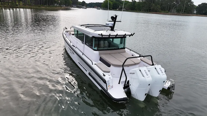 Slide: The Image of 2025 Axopar 37 XC Cross Cabin on calm water. - 36