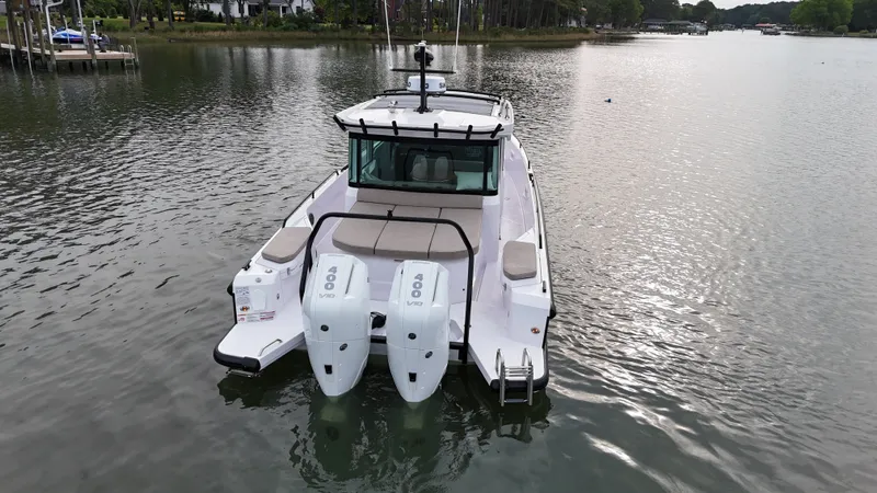 Slide: The Image of Axopar 37 XC Cross Cabin 2025 on calm waters. - 37