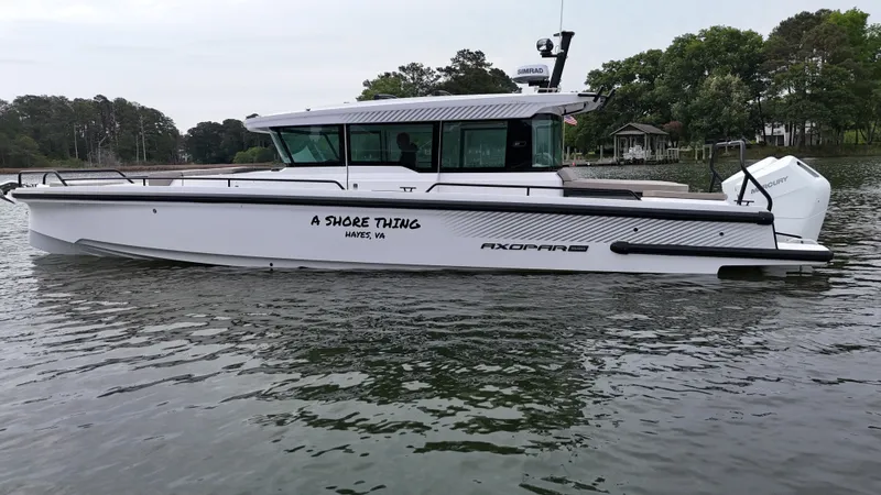 Slide: The Image of 2025 Axopar 37 XC Cross Cabin on calm water. - 41