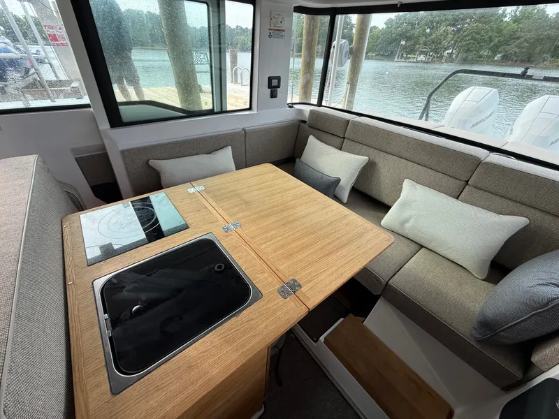 Slide: The Image of Interior of 2025 Axopar 37 XC Cross Cabin with cozy seating area. - 5