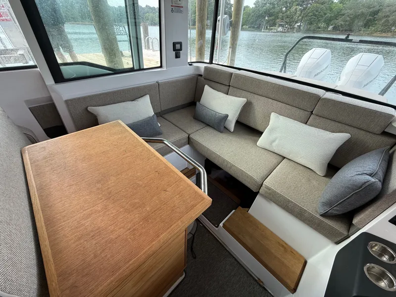 Slide: The Image of Interior of 2025 Axopar 37 XC Cross Cabin with cozy seating area. - 6