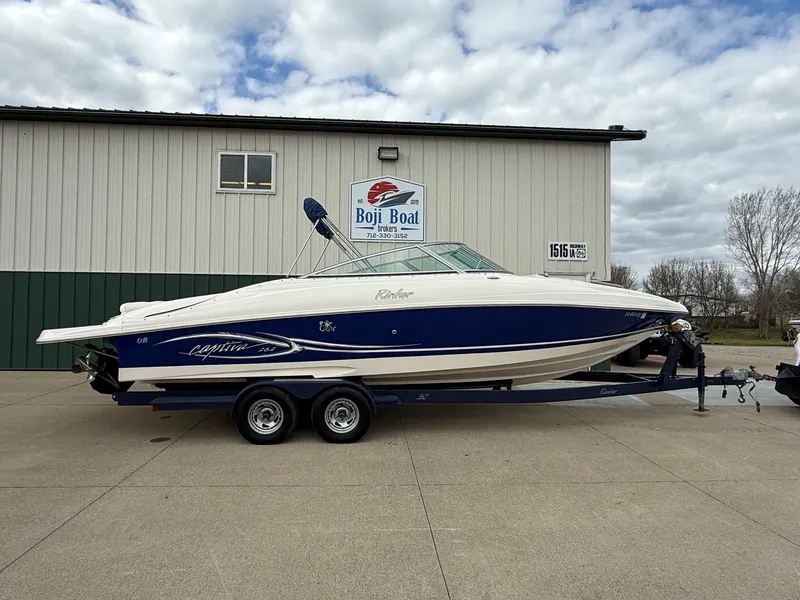 The Image of 2004 Rinker 262 Captiva Bowrider on trailer outside boathouse. - 0