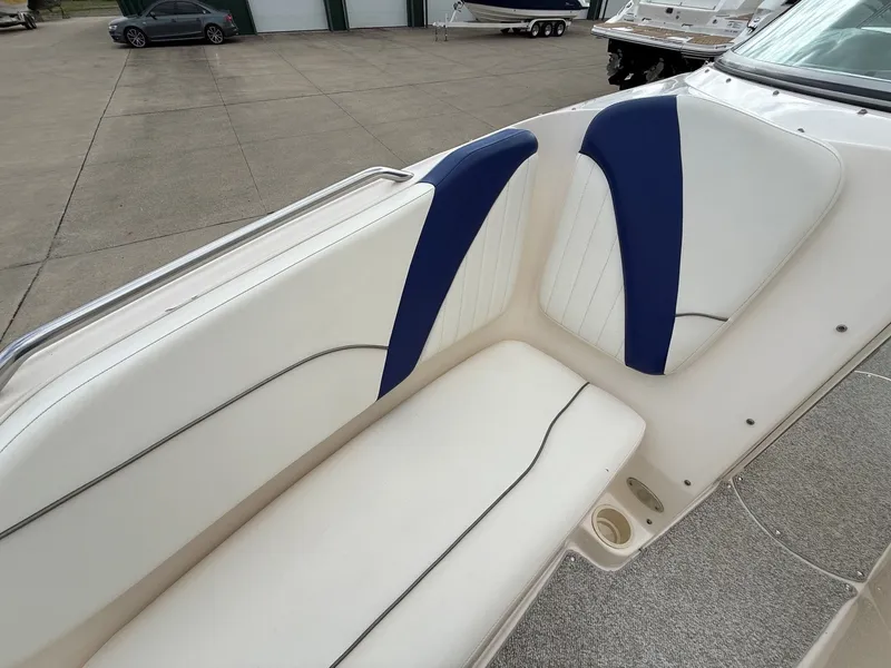 Slide: The Image of 2004 Rinker 262 Captiva Bowrider seating area with blue accents. - 11