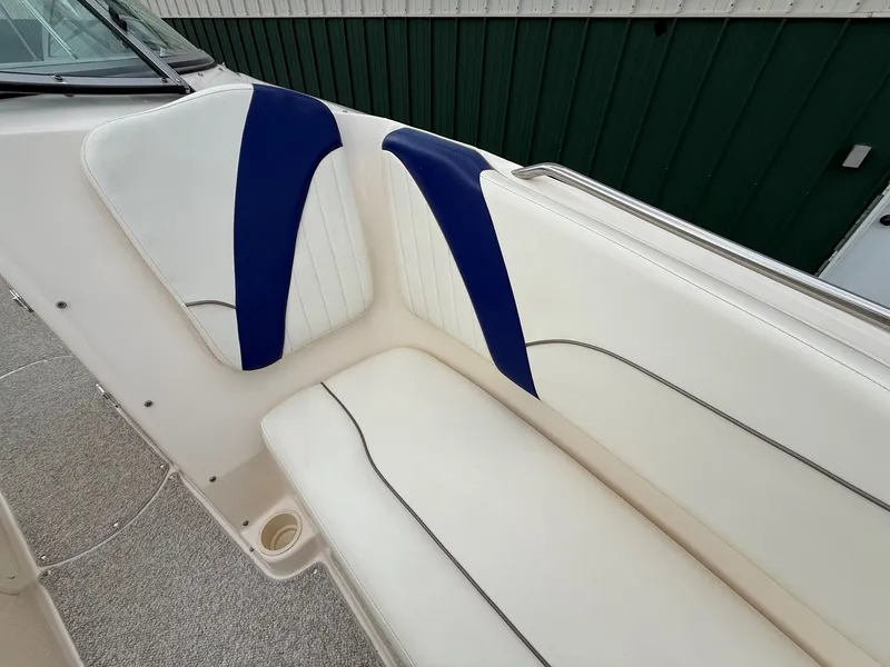 Slide: The Image of Interior of 2004 Rinker 262 Captiva Bowrider with blue and white seating. - 12