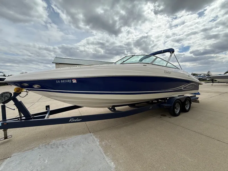 Slide: The Image of 2004 Rinker 262 Captiva Bowrider on trailer under cloudy sky. - 2