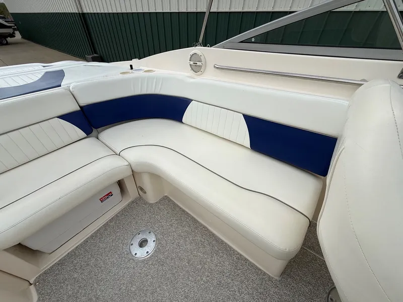 Slide: The Image of Interior of 2004 Rinker 262 Captiva Bowrider with blue and white seating. - 21