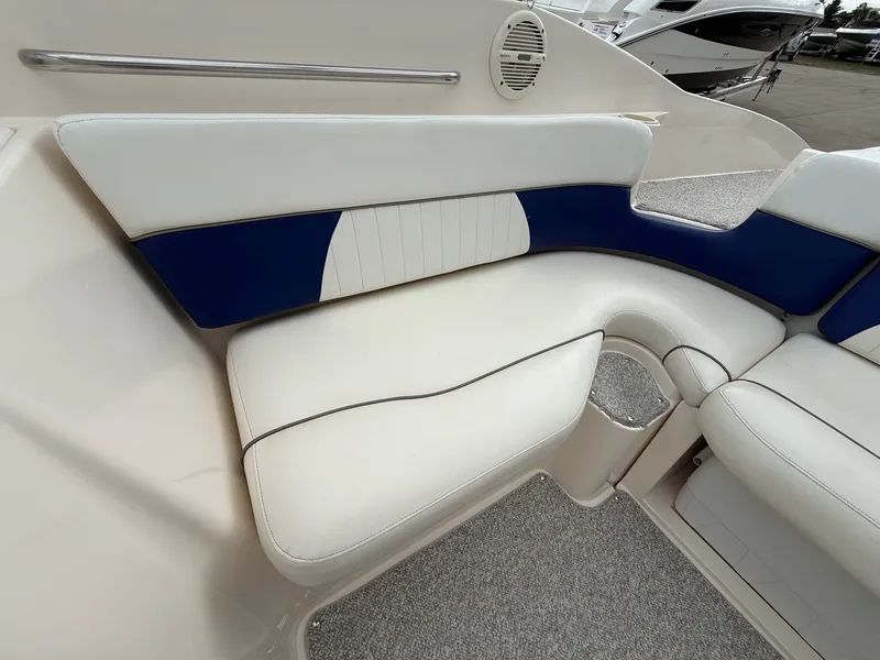 Slide: The Image of Interior of 2004 Rinker 262 Captiva Bowrider with blue and white seating. - 23