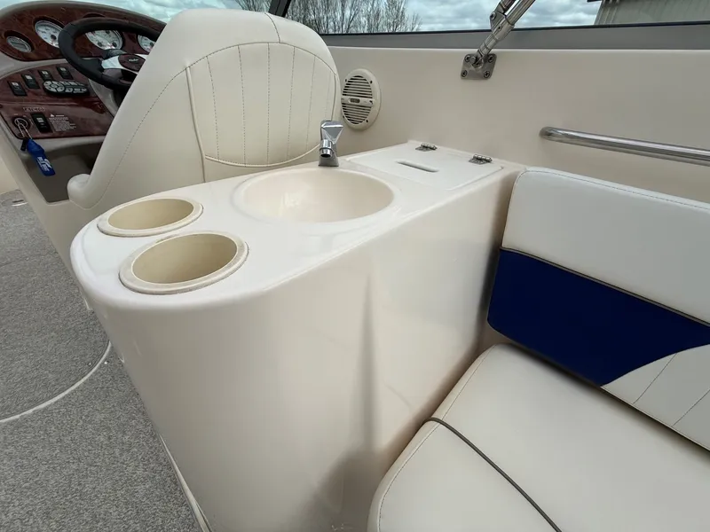 Slide: The Image of Interior of a 2004 Rinker 262 Captiva Bowrider with dashboard and seating area. - 24