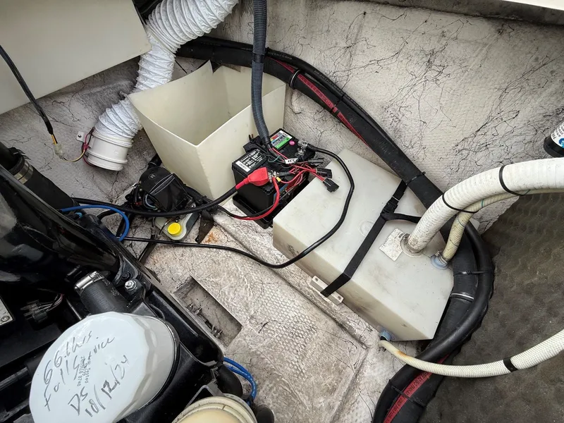 Slide: The Image of Interior of a 2004 Rinker 262 Captiva Bowrider boat with battery and cables. - 26