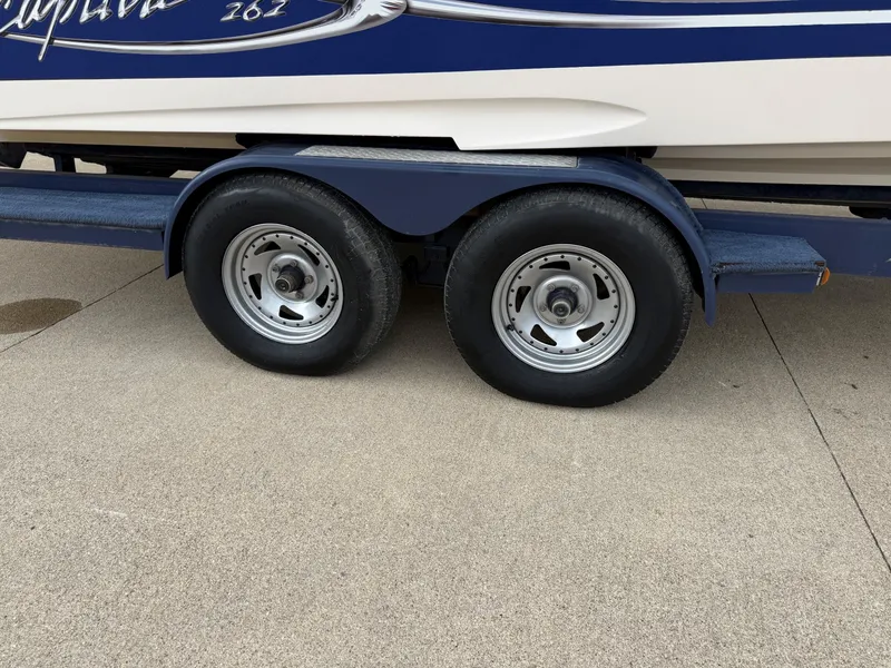 Slide: The Image of 2004 Rinker 262 Captiva Bowrider on trailer, close-up of wheels. - 27