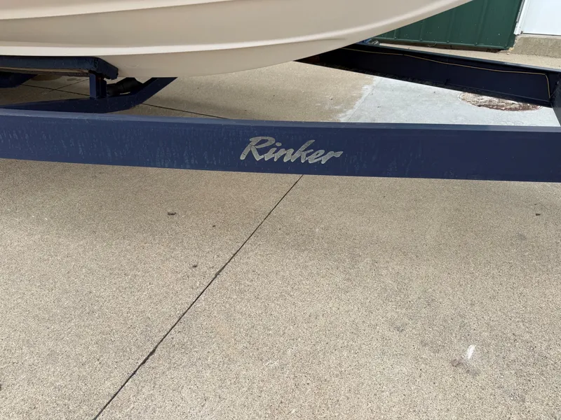 Slide: The Image of Rinker 262 Captiva Bowrider boat trailer, year 2004, on concrete surface. - 28