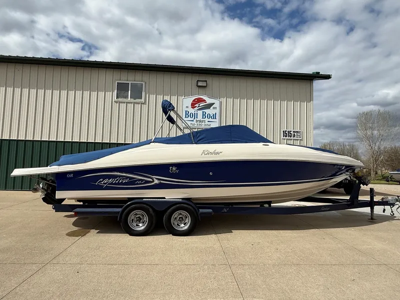 Slide: The Image of 2004 Rinker 262 Captiva Bowrider on trailer outside boathouse. - 30
