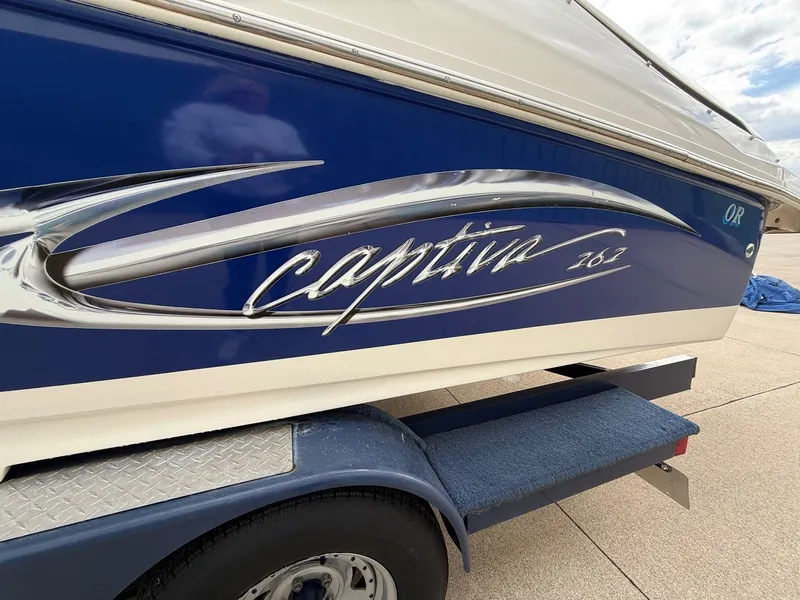 Slide: The Image of 2004 Rinker 262 Captiva Bowrider boat side view. - 5