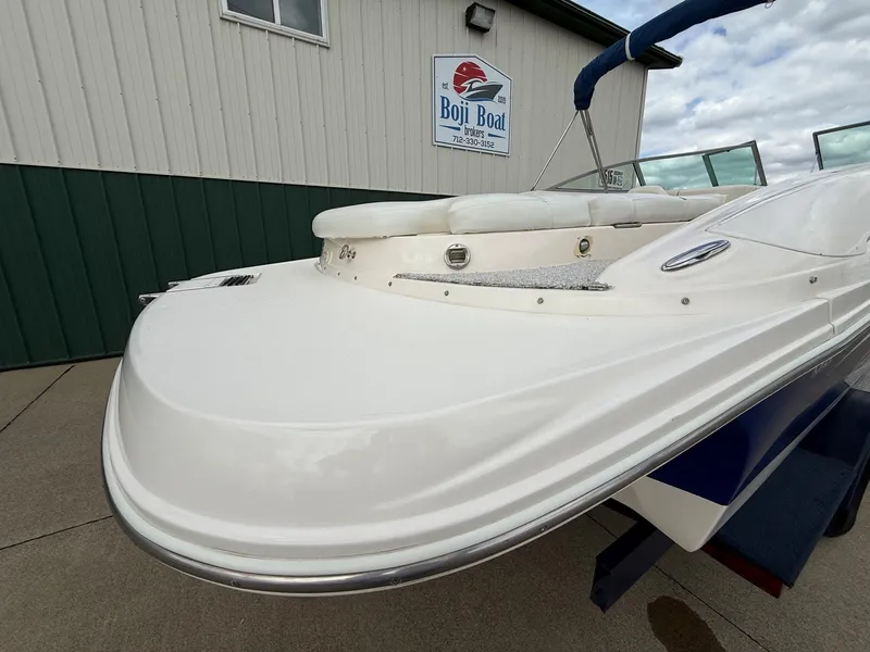 Slide: The Image of 2004 Rinker 262 Captiva Bowrider in front of Boji Boat building. - 6