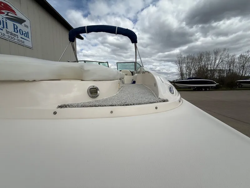 Slide: The Image of 2004 Rinker 262 Captiva Bowrider at a boatyard under cloudy skies. - 8