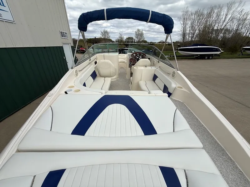Slide: The Image of 2004 Rinker 262 Captiva Bowrider with blue and white seating. - 9