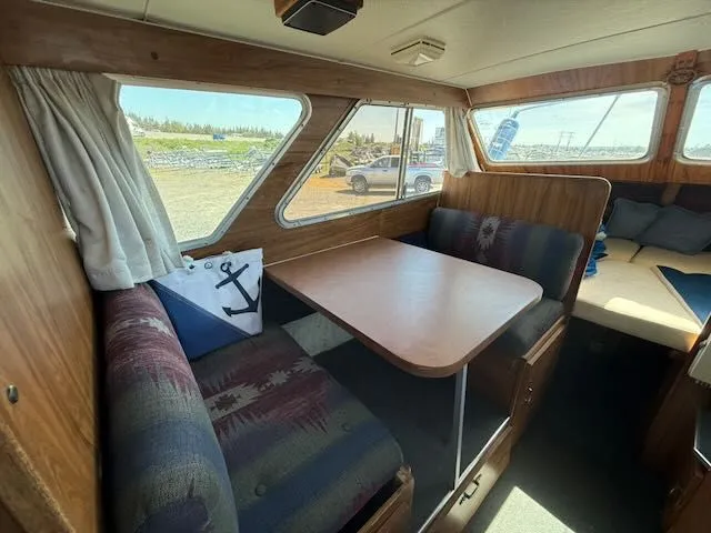 Slide: The Image of Interior of a 1979 Tollycraft 26 with cozy seating and table. - 11