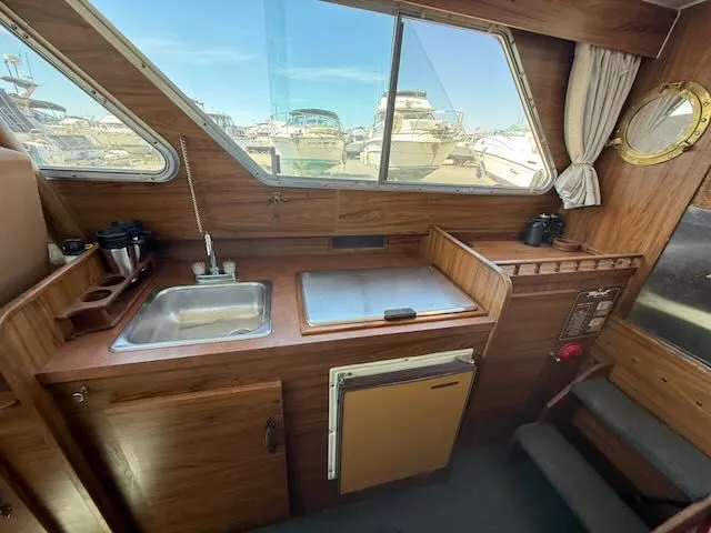 Slide: The Image of Interior of 1979 Tollycraft 26 yacht featuring kitchen and sink. - 12
