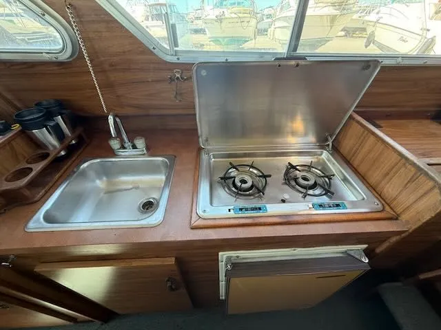 Slide: The Image of 1979 Tollycraft 26 kitchen area with sink and stove. - 13