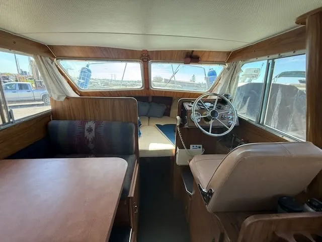 Slide: The Image of Interior of a 1979 Tollycraft 26 boat with helm and seating area. - 15