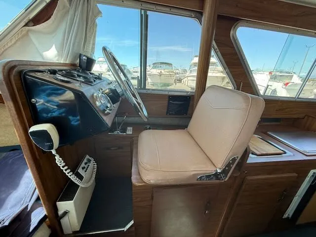 Slide: The Image of Interior of a 1979 Tollycraft 26 boat with helm and seat. - 16