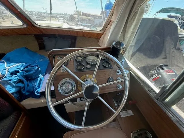 Slide: The Image of 1979 Tollycraft 26 boat helm with gauges and steering wheel. - 17