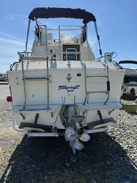 Slide: The Image of Rear view of a 1979 Tollycraft 26 boat on gravel. - 2
