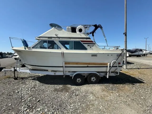Slide: The Image of 1979 Tollycraft 26 boat on trailer outdoors. - 27