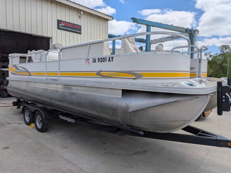 Slide: The Image of 2005 Princecraft Pontoon boat on trailer outside workshop. - 2
