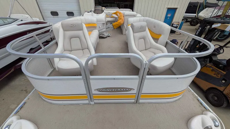 Slide: The Image of 2005 Princecraft Pontoon boat with beige seats and yellow accents. - 4