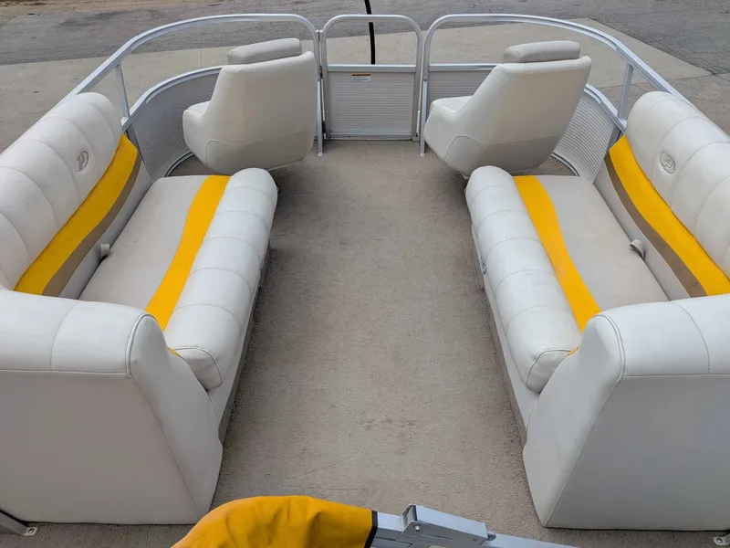 Slide: The Image of Interior of a 2005 Princecraft Pontoon boat with white and yellow seating. - 5