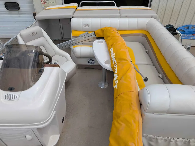 Slide: The Image of Interior of a 2005 Princecraft Pontoon boat with yellow accents. - 6