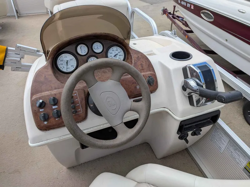 Slide: The Image of 2005 Princecraft Pontoon boat console with steering wheel and gauges. - 7
