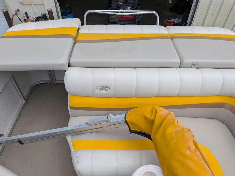 Slide: The Image of Interior of a 2005 Princecraft Pontoon boat with yellow accents. - 9