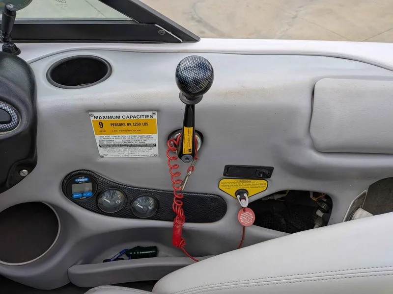 Slide: The Image of Interior view of a 2000 Correct Craft Air Nautique boat with controls. - 9