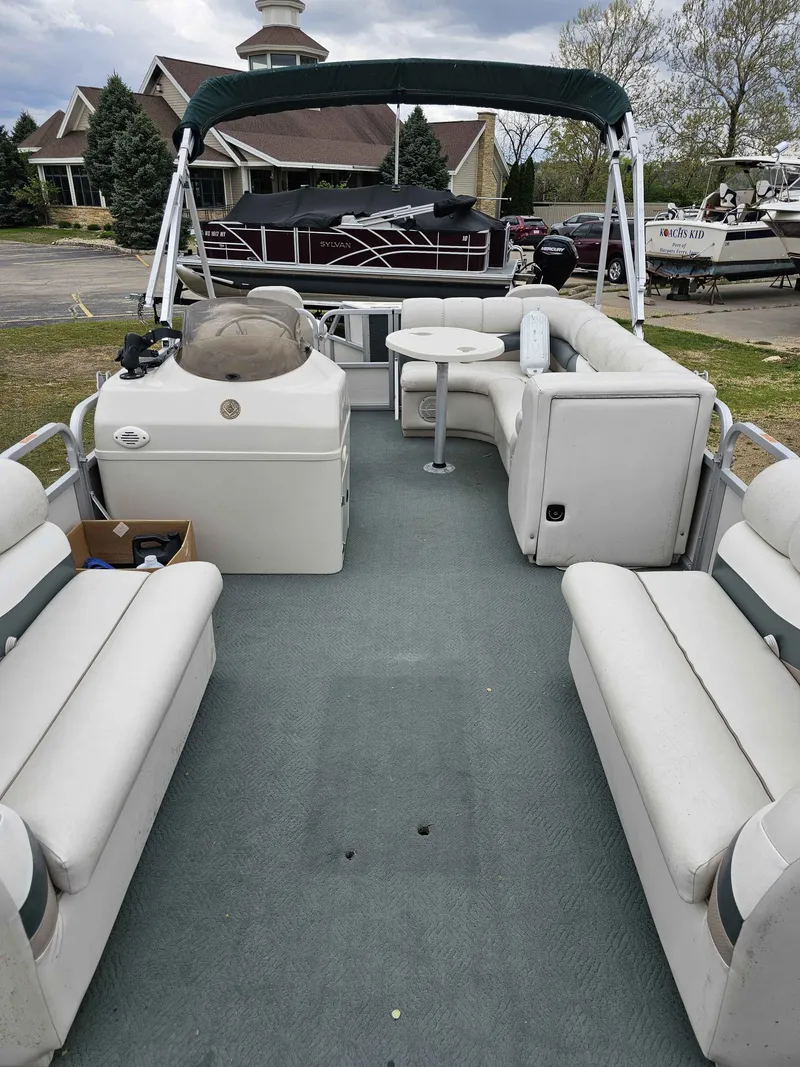Slide: The Image of Interior of a 2004 Manitou Osprey 24 pontoon boat with seating. - 5