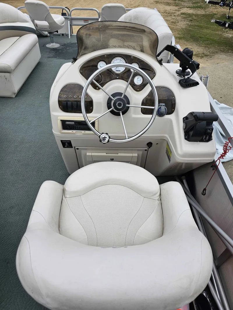 Slide: The Image of Helm console of a 2004 Manitou Osprey 24 pontoon boat. - 6