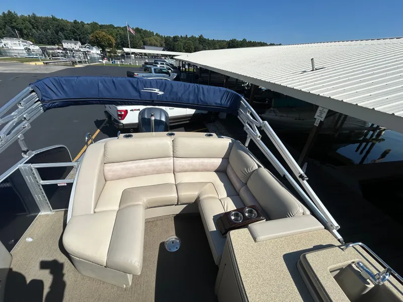 Slide: The Image of 2014 Bennington R2550 pontoon boat with beige seating and blue canopy. - 11