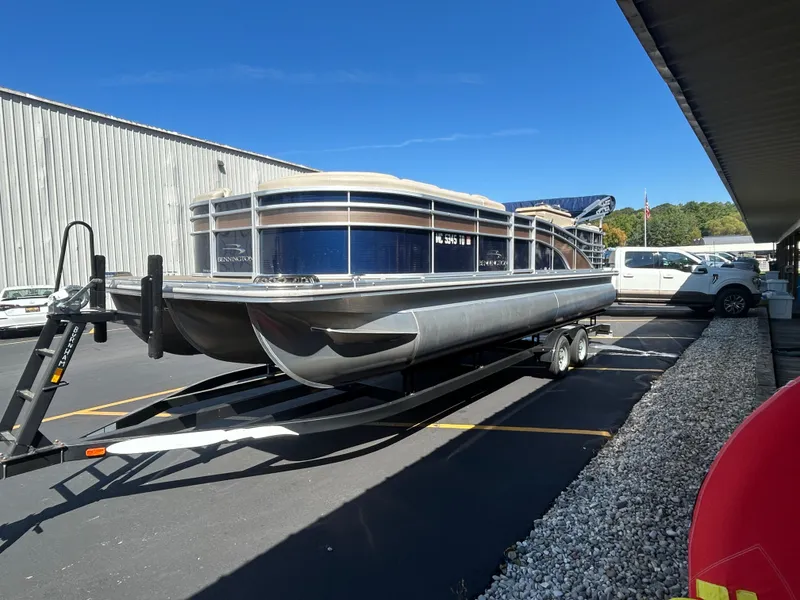 Slide: The Image of 2014 Bennington R2550 pontoon boat parked on trailer outdoors. - 3