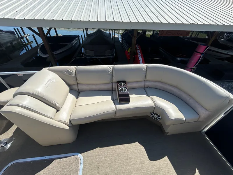 Slide: The Image of 2014 Bennington R2550 pontoon boat with beige leather sofa and cup holders. - 8