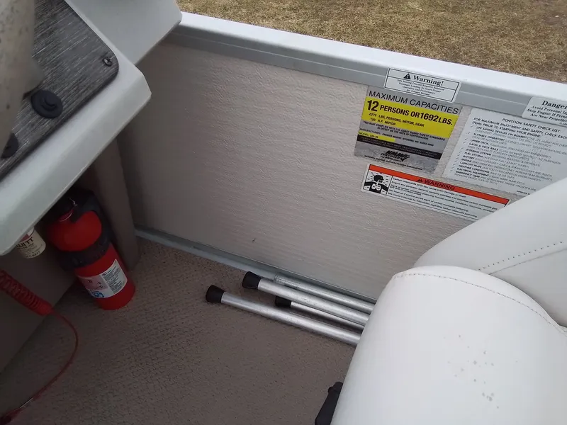 Slide: The Image of Interior of a 2006 Premier 225 Sunsation boat with safety labels. - 23