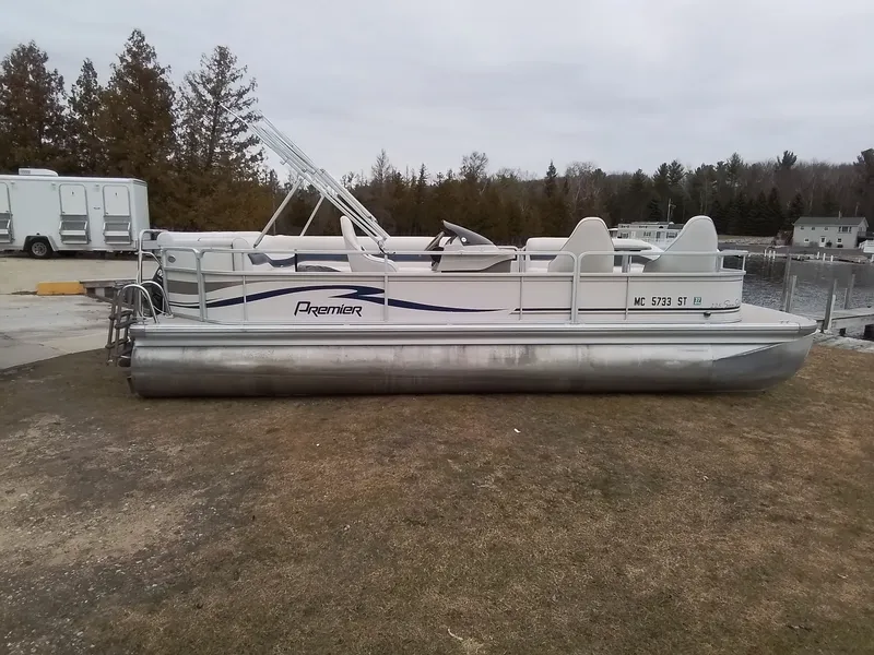 Slide: The Image of 2006 Premier 225 Sunsation pontoon boat parked on grass. - 3